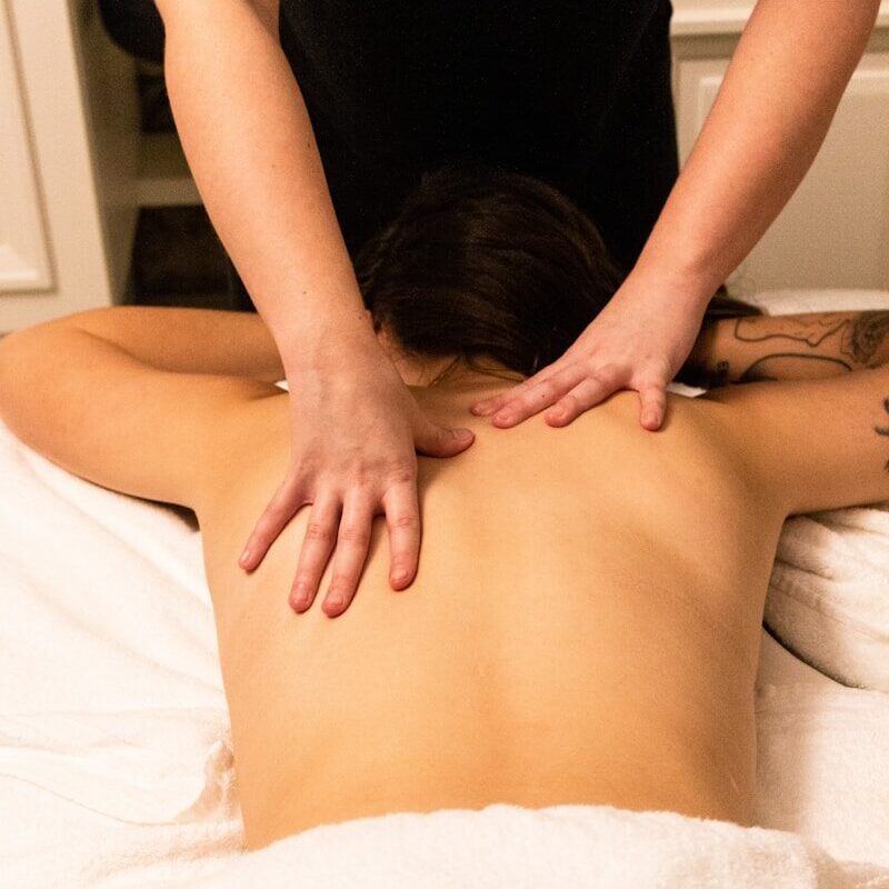 a woman getting a back massage at a spa